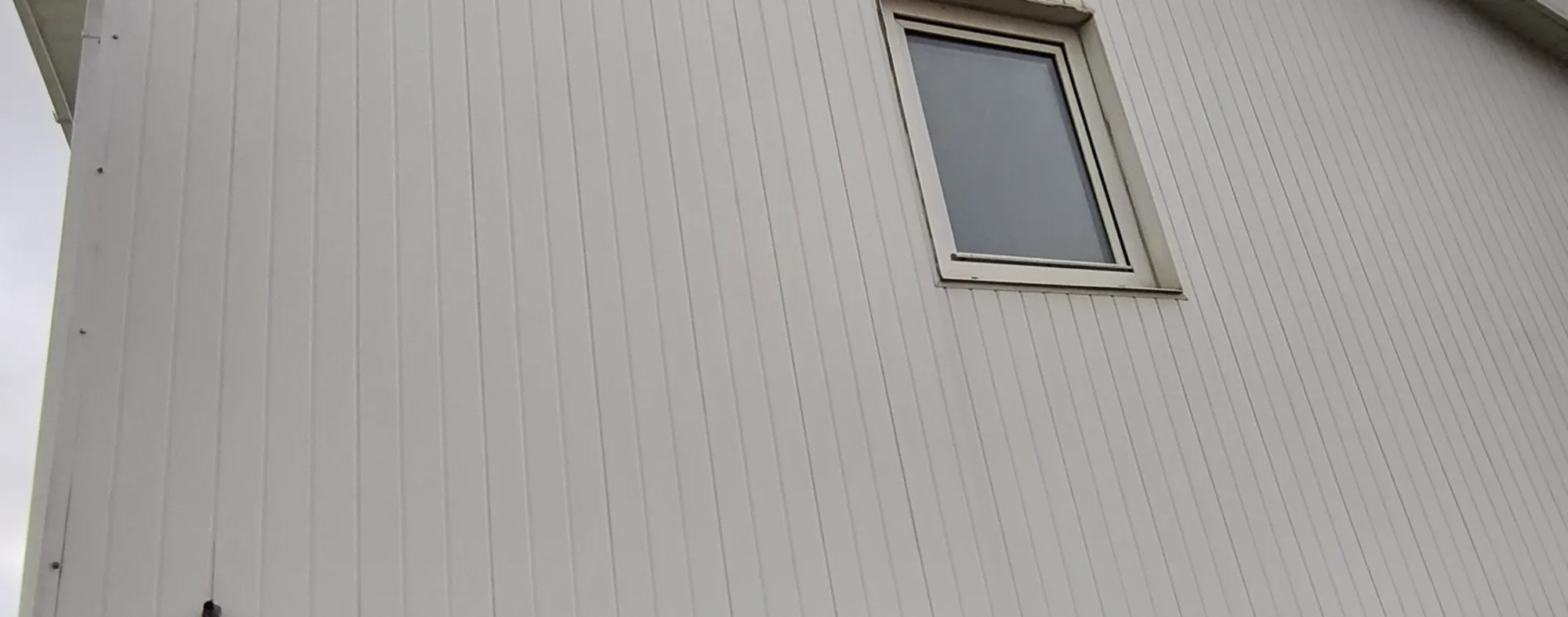 After exterior softwashing: cleaner house exterior with restored finish