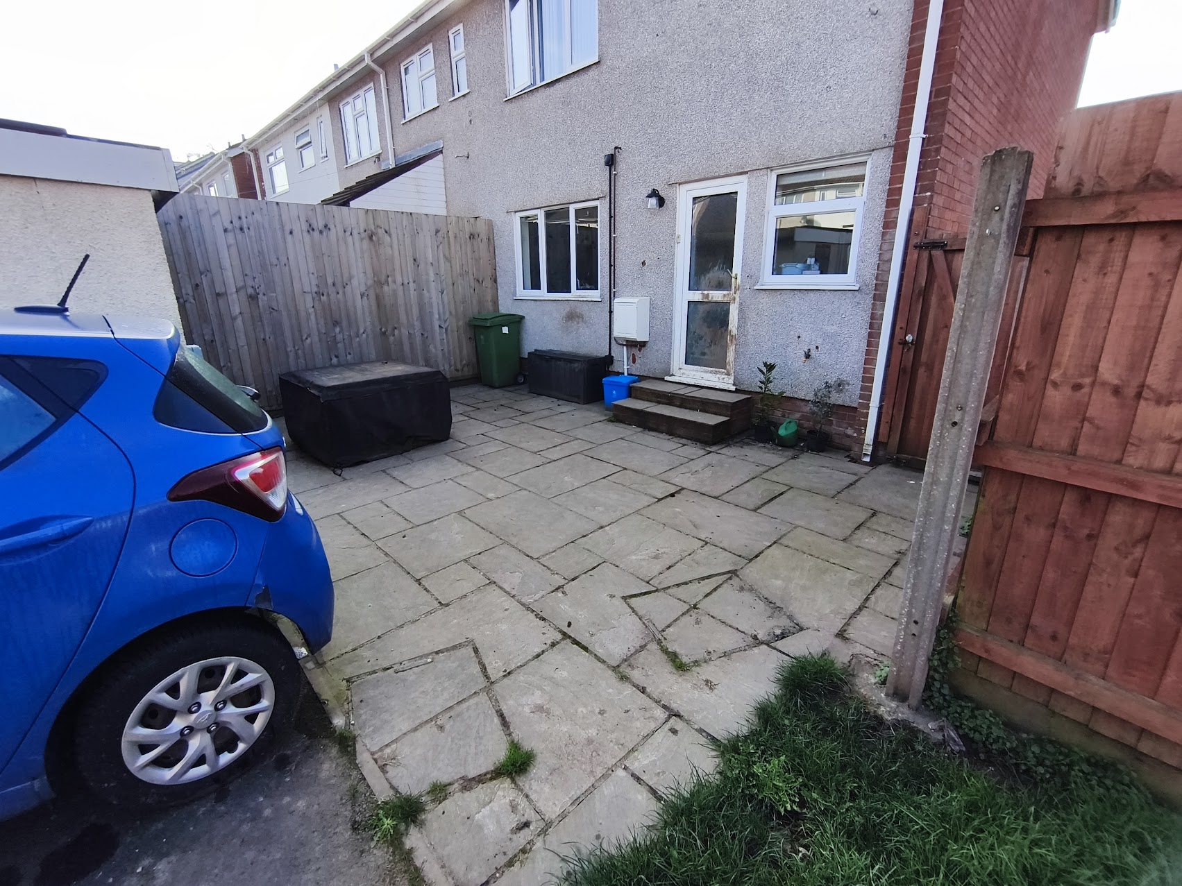 Before patio cleaning: weathered paving with dirt buildup