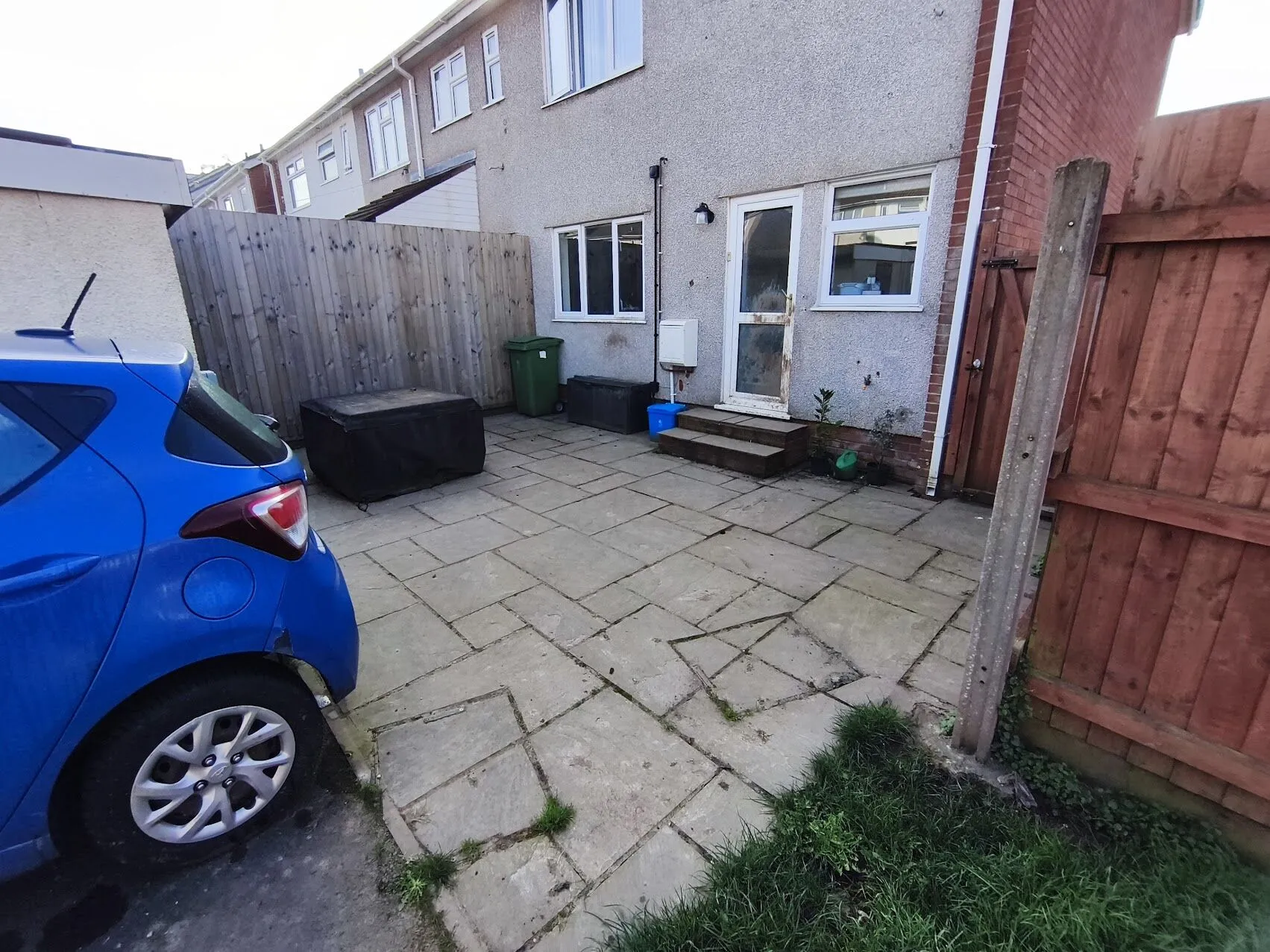 Before patio cleaning: weathered paving with dirt buildup