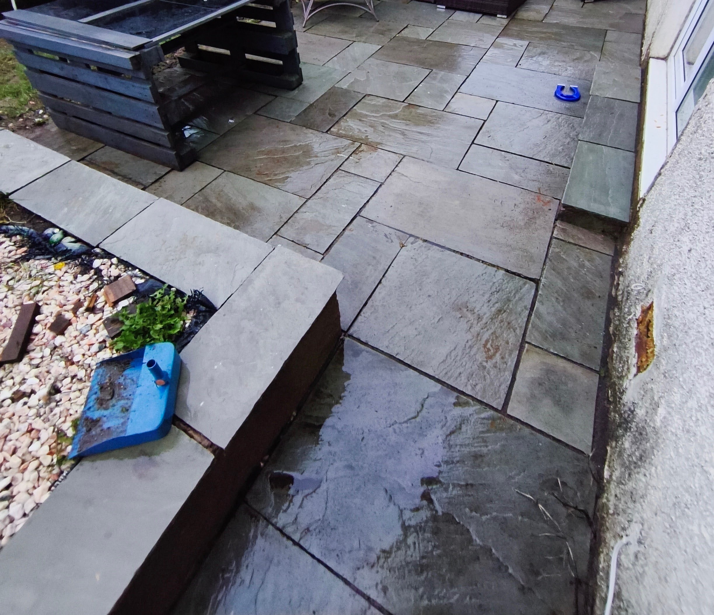 Before patio cleaning and repointing: discoloured joints and weathered paving