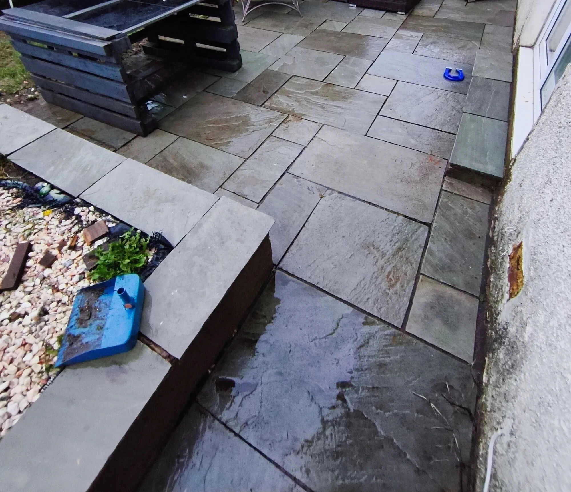 Before patio cleaning and repointing: discoloured joints and weathered paving